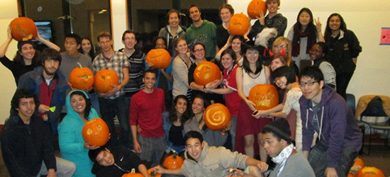 a group of ILC students with carved pumpkins.
